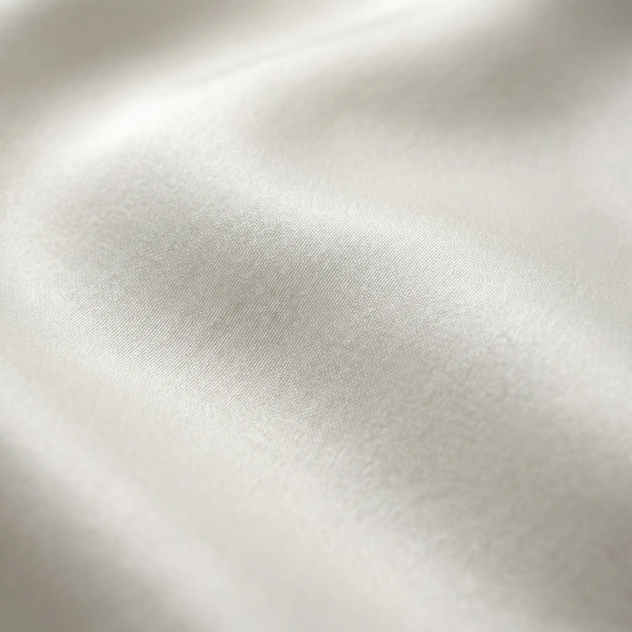 SELVANE pure white bow-tie blouse and wide-leg trousers set in luminous, crinkled acetate fabric, styled elegantly.