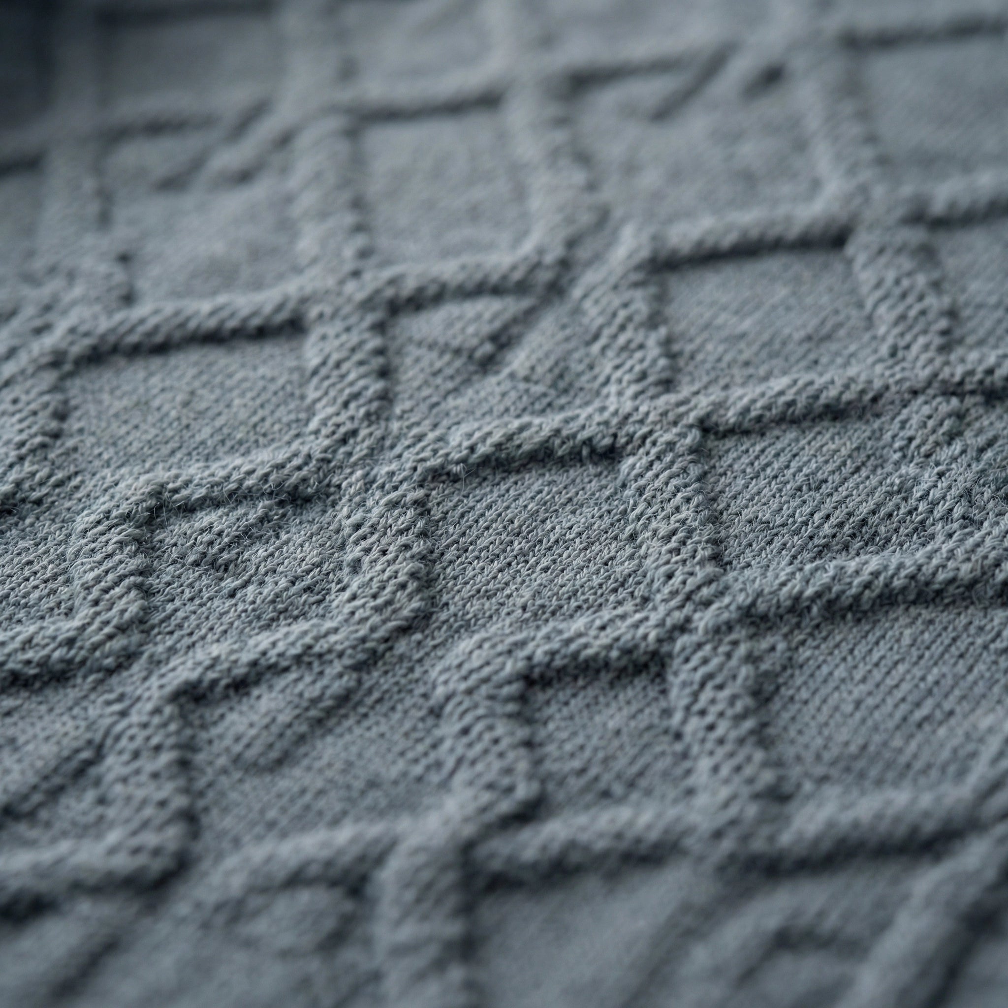 Sleeveless SELVANE Jacquard Knit Tank in muted grey-blue, featuring intricate diamond pattern, horizontal stripes, scoop neckline, and ribbed hem.