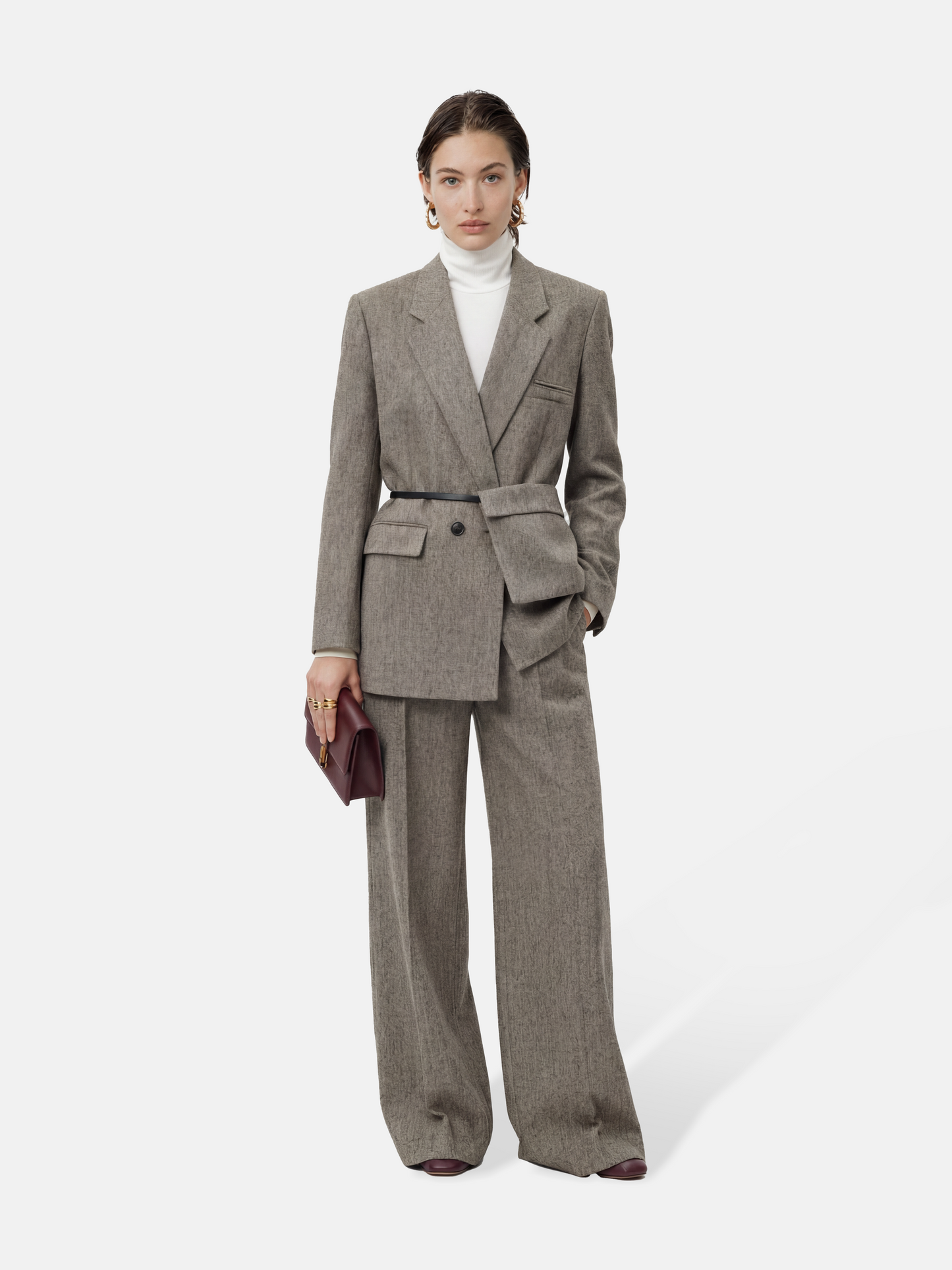 SELVANE heather grey tailored suit set, elongated body, shaped waist with asymmetric belt, on a model.