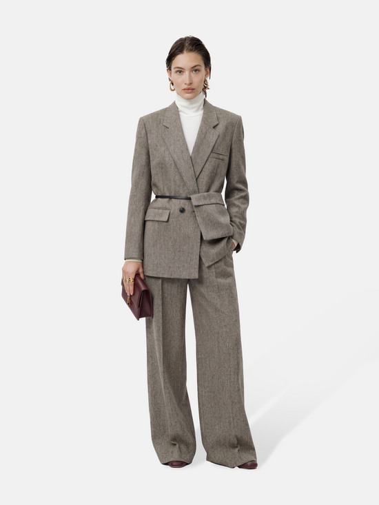 SELVANE heather grey tailored suit set, elongated body, shaped waist with asymmetric belt, on a model.
