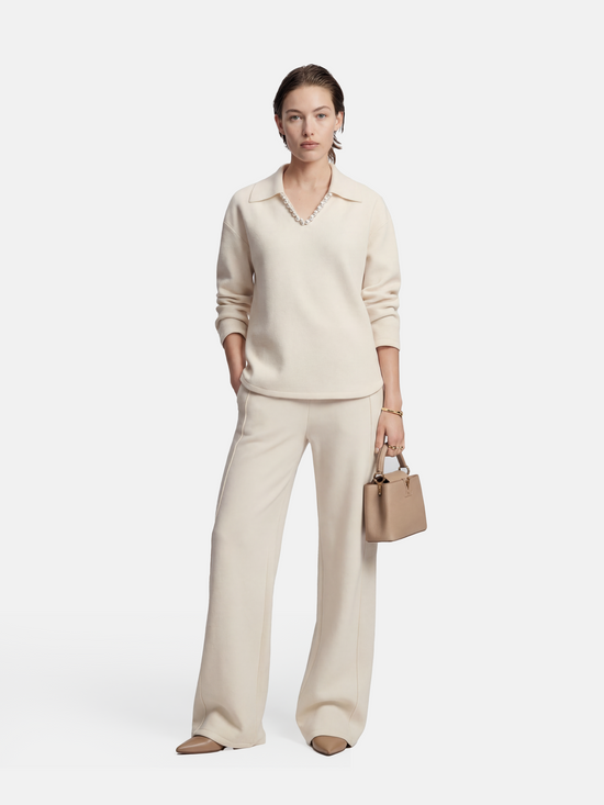 Off-white SELVANE Collared Knit Pullover and Wide-Leg Pants Set, featuring a V-neck and fluid silhouette.