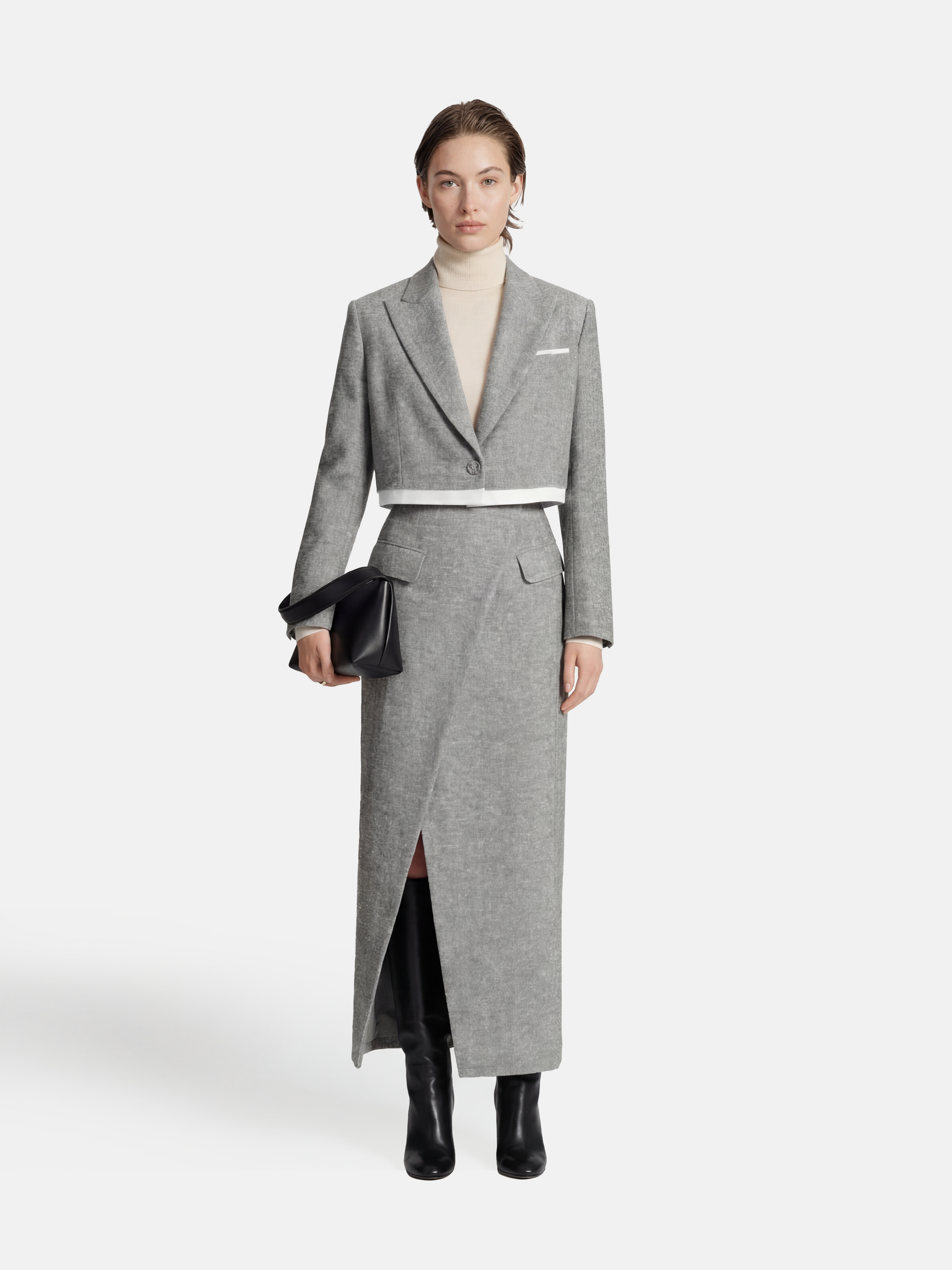 Cropped blazer and wrap midi skirt set in grey, featuring disciplined shoulders and fluid lines, inspired by volcanic terrain.