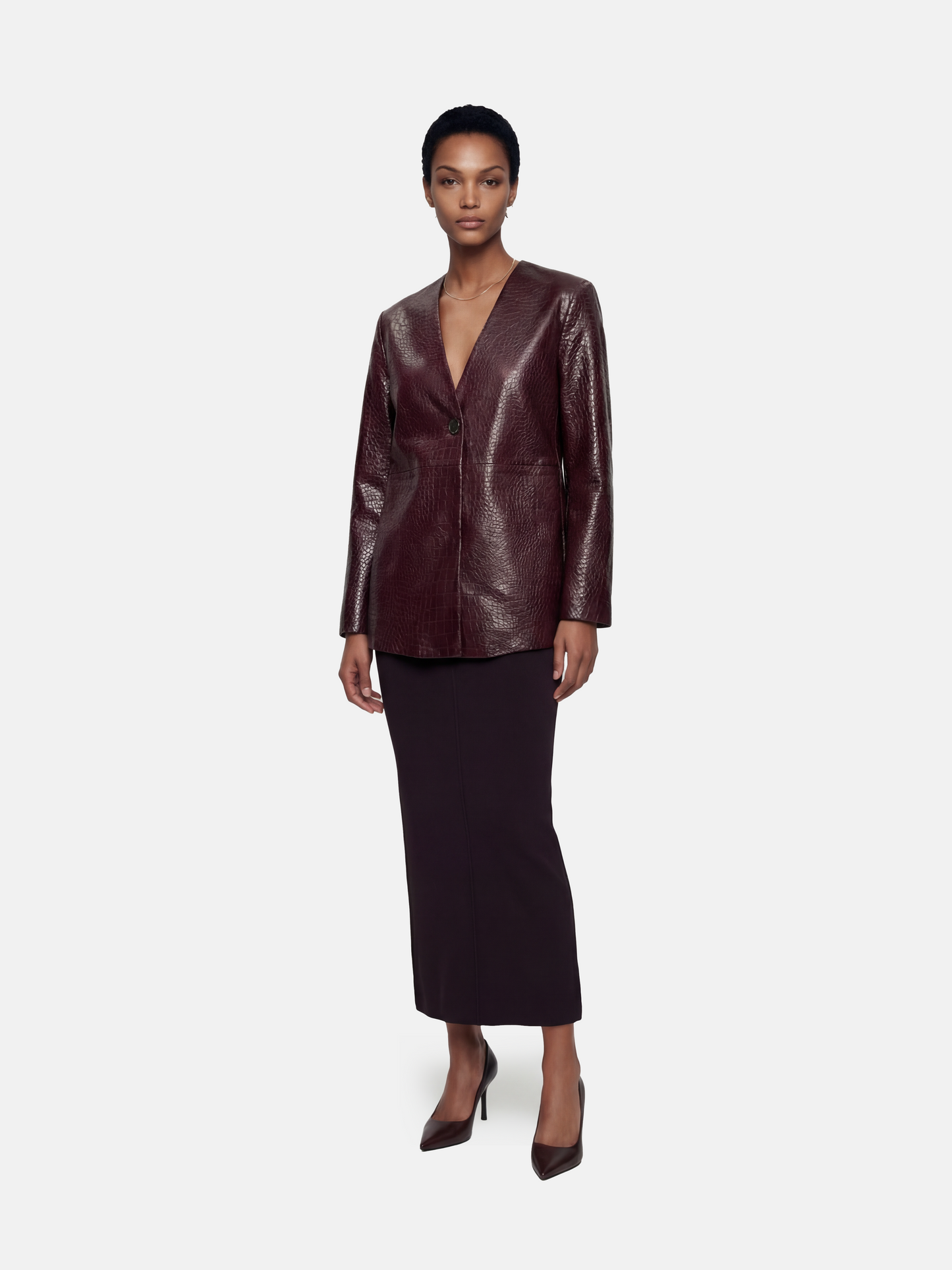 Deep oxblood embossed lambskin V-neck jacket, collarless with a single closure, shown on a model.