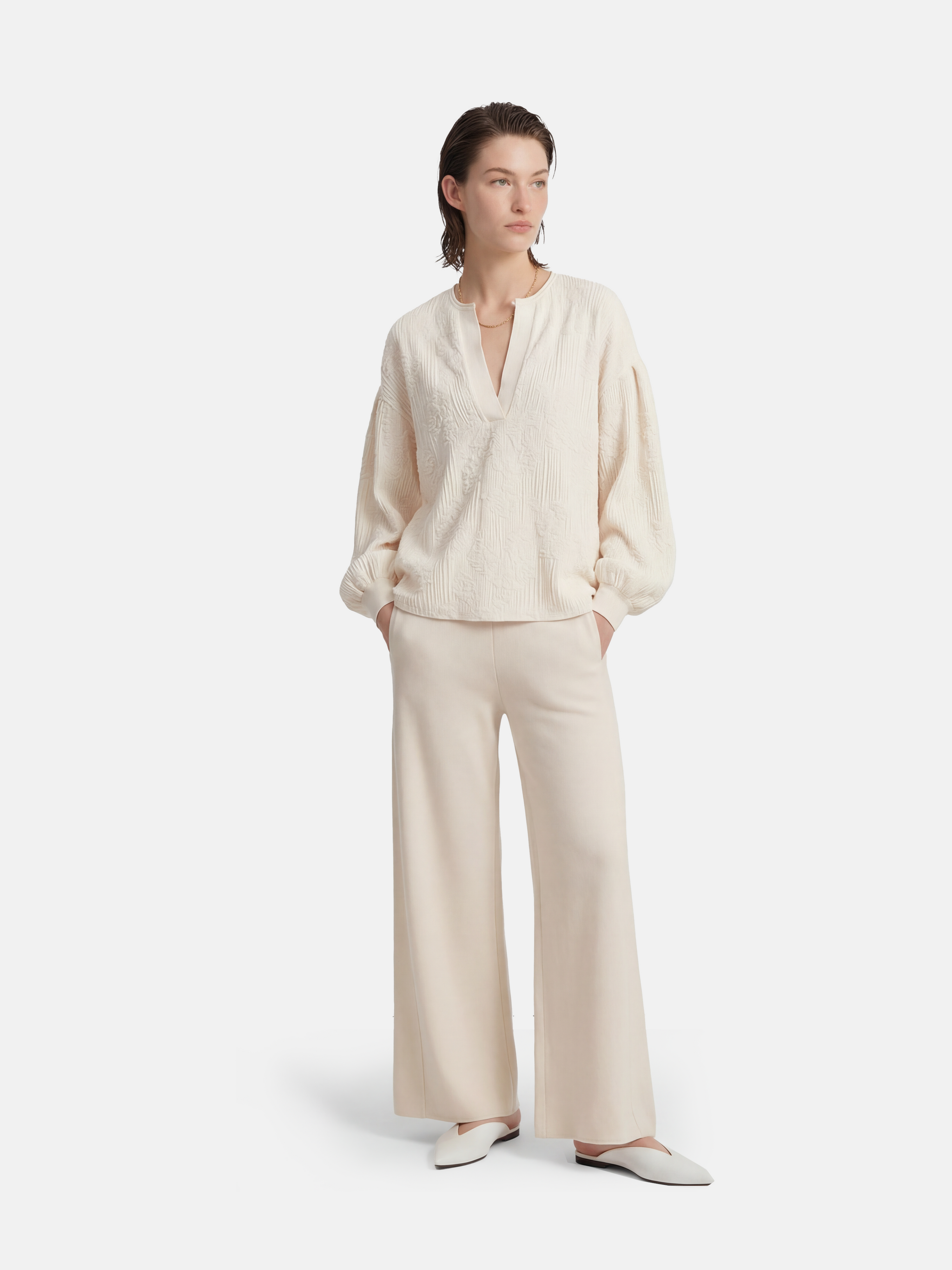 Ivory cashmere wide-leg pants by SELVANE, featuring a soft V-shaped rib waistband and elegant vertical drape.