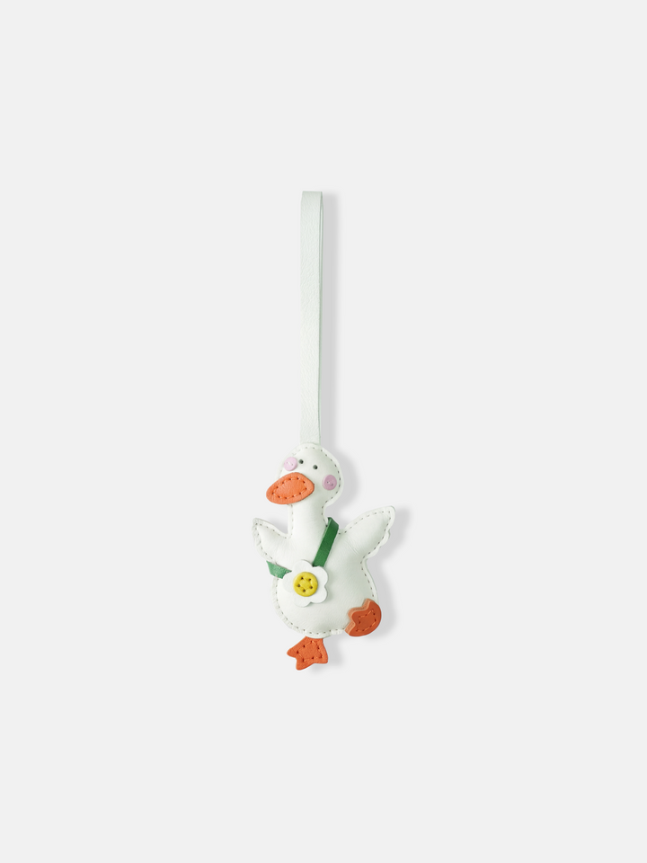 Selvane Daisy Duck bag charm, featuring a rounded duck silhouette with lifted wings and a central daisy detail, crafted with refined artistry.