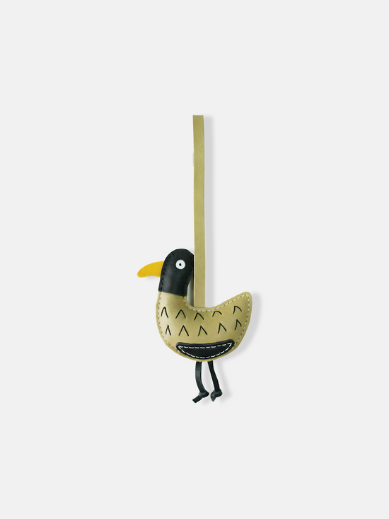 Selvane Little Bird Bag Charm with a long strap, compact yellow bird body, contrast head, curved belly, and slender hanging legs, against a neutral background.