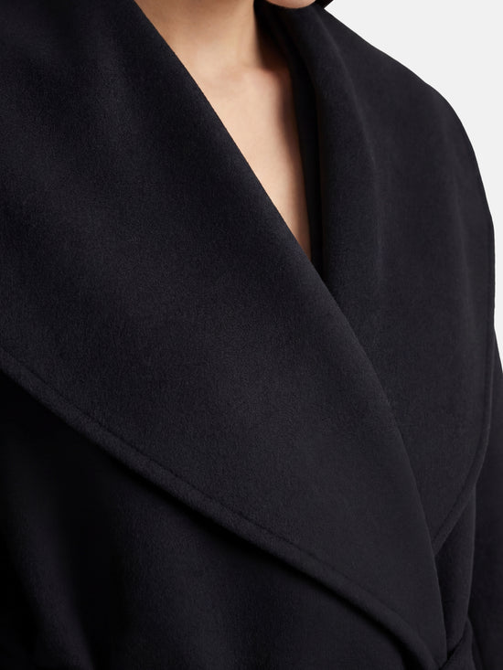 SELVANE mid-length wrap coat in quiet camel pure cashmere, with exaggerated shawl collar and long belt, for elegant motion.