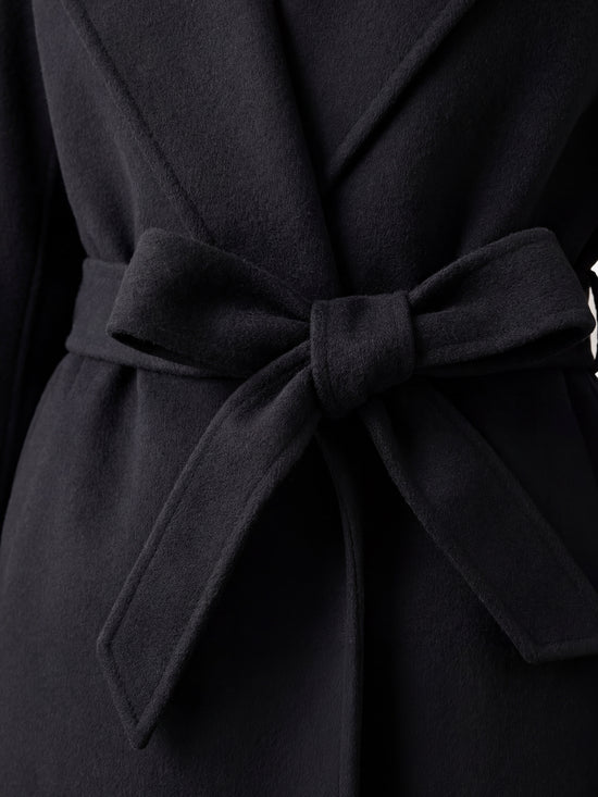 SELVANE mid-length wrap coat in quiet camel pure cashmere, with exaggerated shawl collar and long belt, for elegant motion.