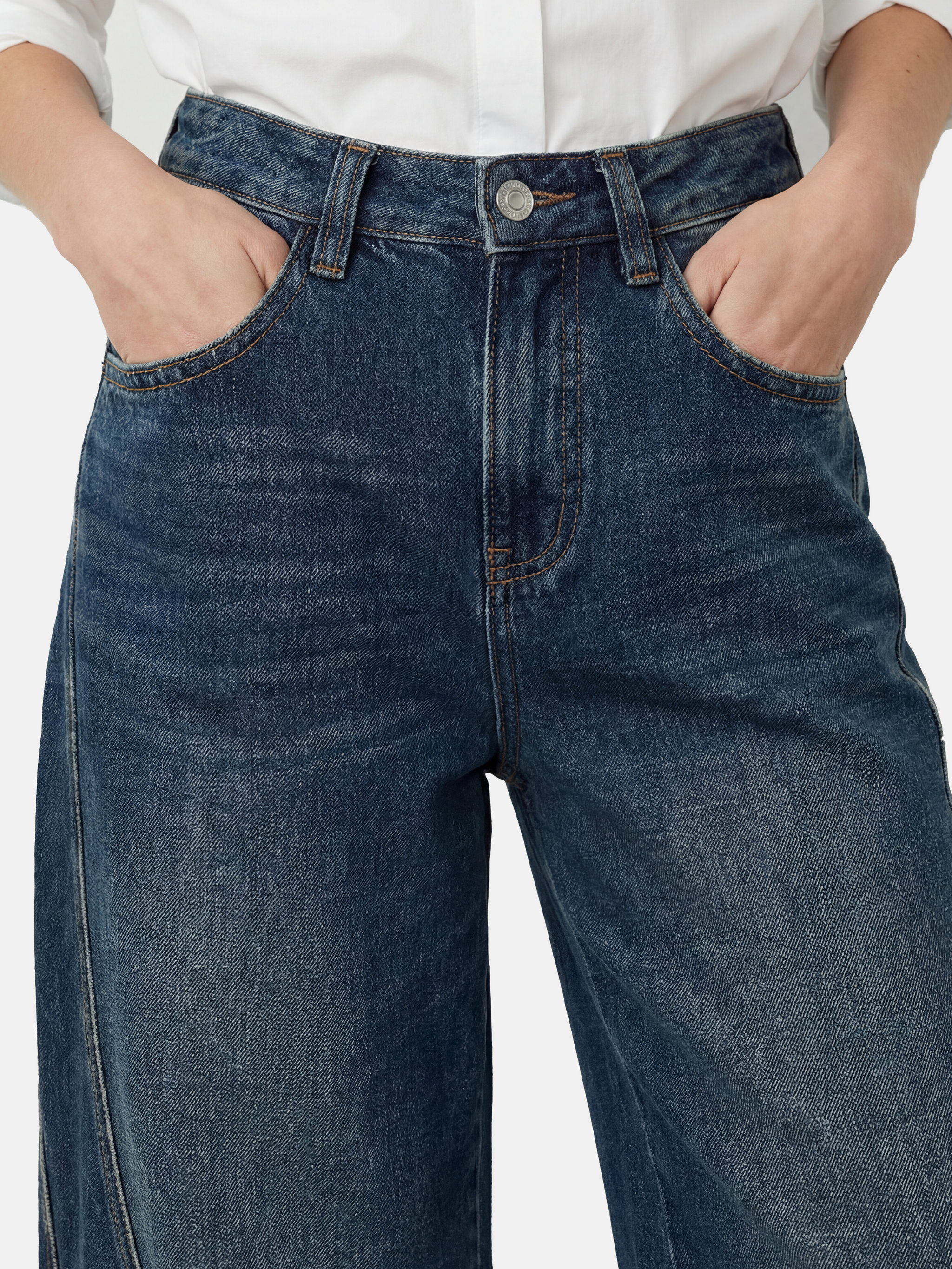 Model wearing high-rise SELVANE Sculpted Seam Wide-Leg Jeans in mid-wash pure cotton denim, showcasing the curved front seams.