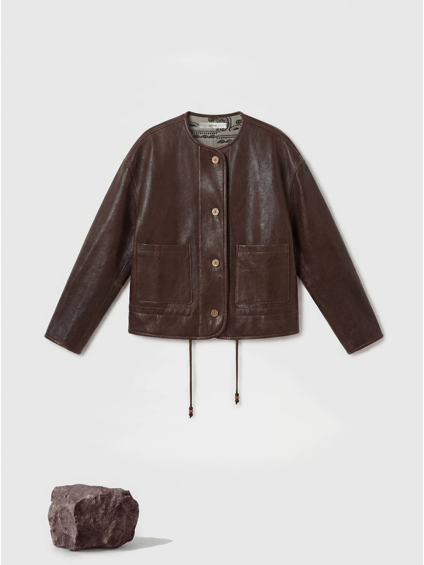 SELVANE brown lambskin crew-neck jacket with softened volume and drawstring hem, showcasing clean lines and supple texture.