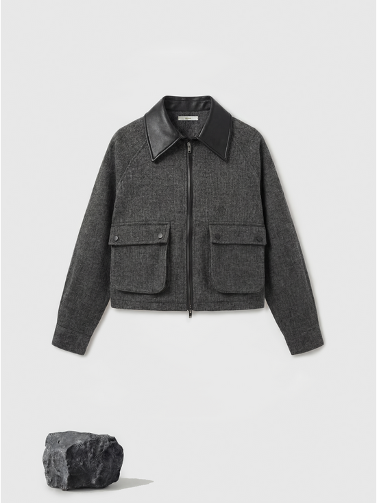 Charcoal wool-blend two-piece set featuring a cropped, boxy jacket with a sharp faux-leather contrast collar and a clean straight skirt.